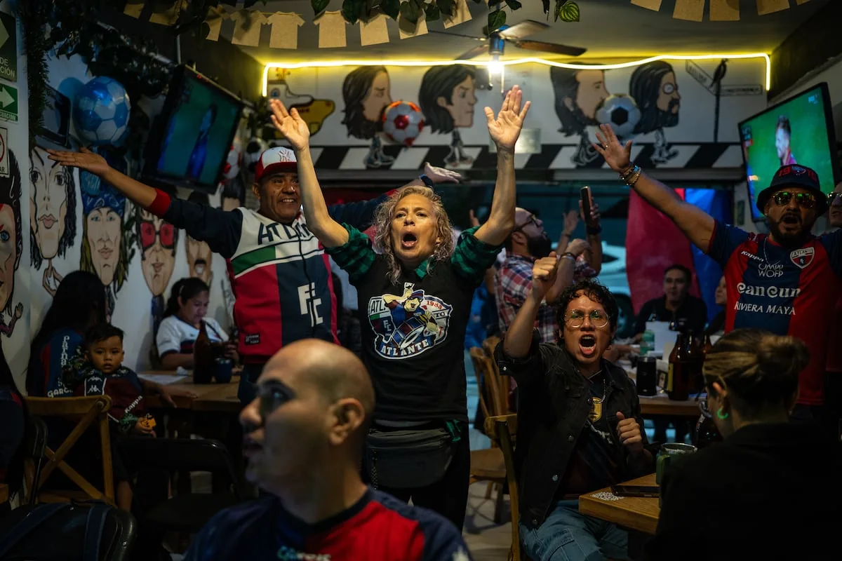 Atlante supporters watch a Liga MX match in a Mexico City bar in 2026